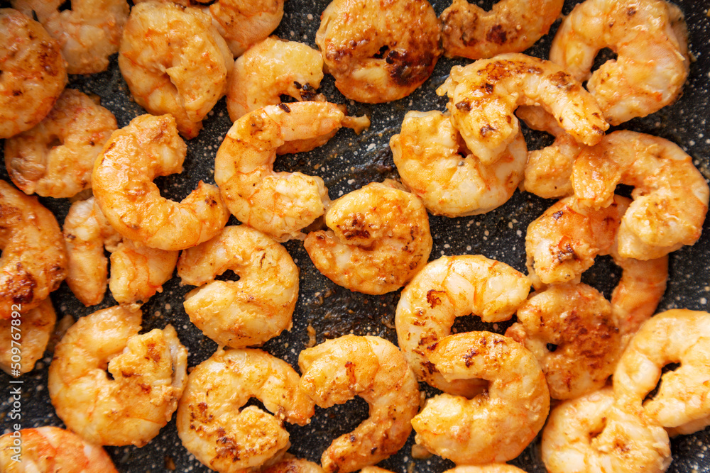 Cooking shrimps on a frypan, top view. Close-up. Cooking shrimps on a frypan, top view. Close-up.