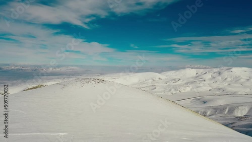 Aerial view snow mountain range landscape clouds in background 4k winter drone footage Ski resort. Erciyes. Turkey. Volcano. Ropeway. aerial truck left. High quality 4k footage