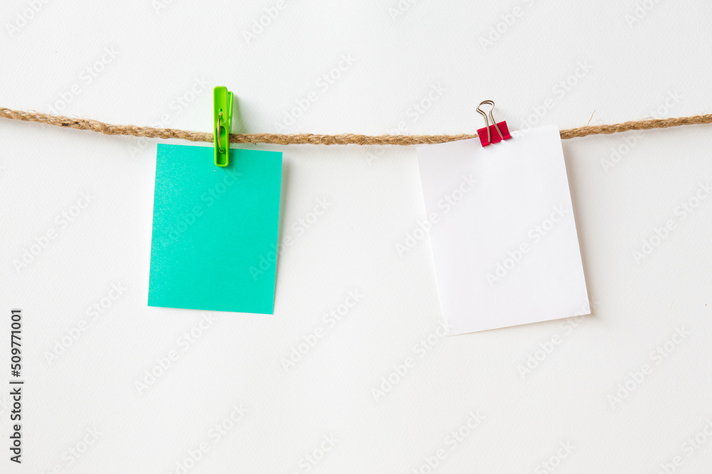 Abstract paper note on Hemp rope with white background. Blank notebook. picture for add text message or used background on website Abstract paper note on Hemp rope with white background. Blank notebook. picture for add text message or used background on website