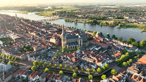 Kampen city skyline aerial view from the river IJssel with the sunset in the distance during a springtime evening. photo