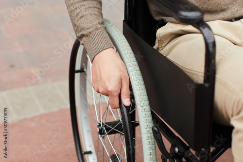 Fotografiet Close-up of unrecognizable man practicing ride in modern wheelchair while recove