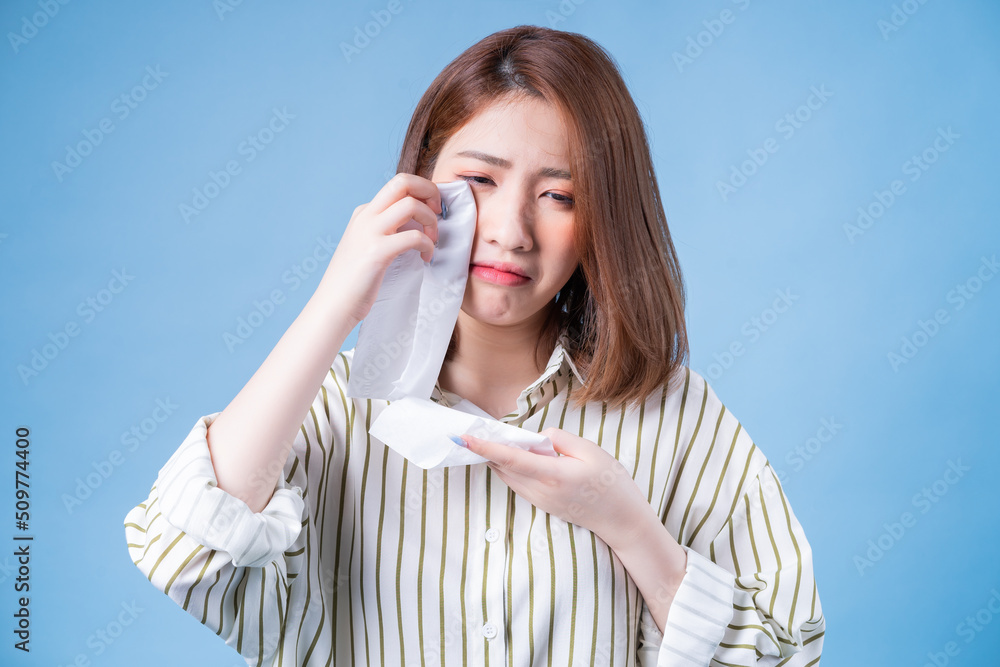 Image of young Asian girl posing on blue background Image of young Asian girl posing on blue background