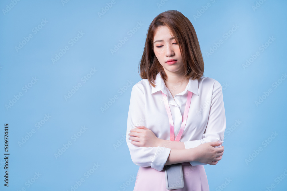 Image of young Asian businesswoman on blue background Image of young Asian businesswoman on blue background