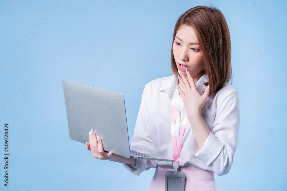 Image of young Asian businesswoman on blue background Image of young Asian businesswoman on blue background