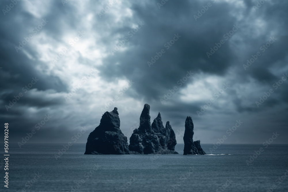 Dramatic clouds at Reynisdrangar, a cliff formation in the ocean near Reynifjara beach, Iceland