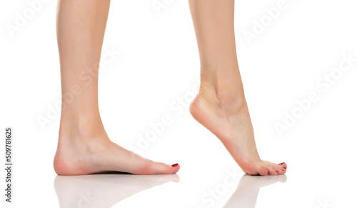 Side view of a beautifully cared female feet on a white background © vladimirfloyd