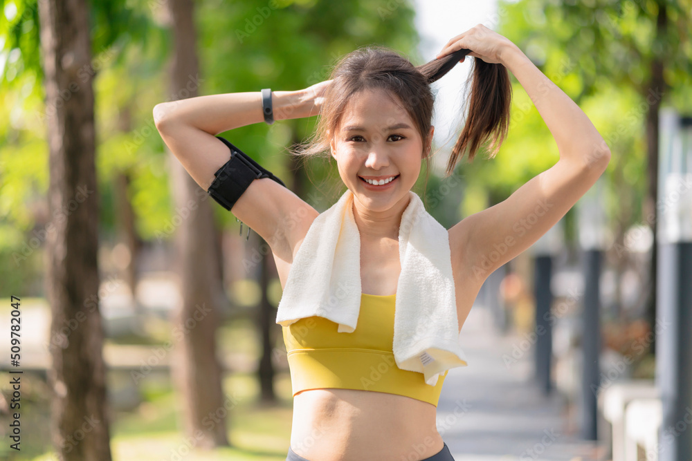 Fototapeta premium sport asian female teen portrait shot while morning running jogging healthy routine activity sunnday at public park,asia woman wear sport wear smile look at camera while take a break from run exercise