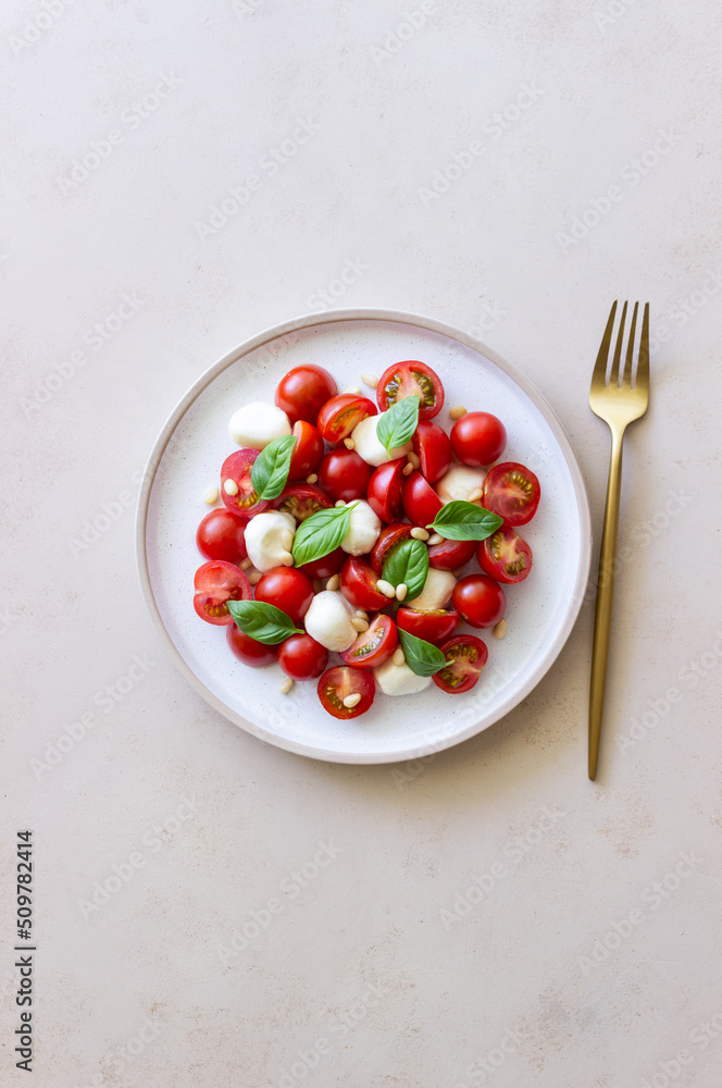 Salad with mozzarella, tomatoes, nuts and basil. Healthy eating. Vegetarian food. Diet. Salad with mozzarella, tomatoes, nuts and basil. Healthy eating. Vegetarian food. Diet.