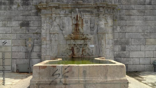 Water Fountain near Pillory of Porto Square with Cathedral in Background on Sunny Day photo