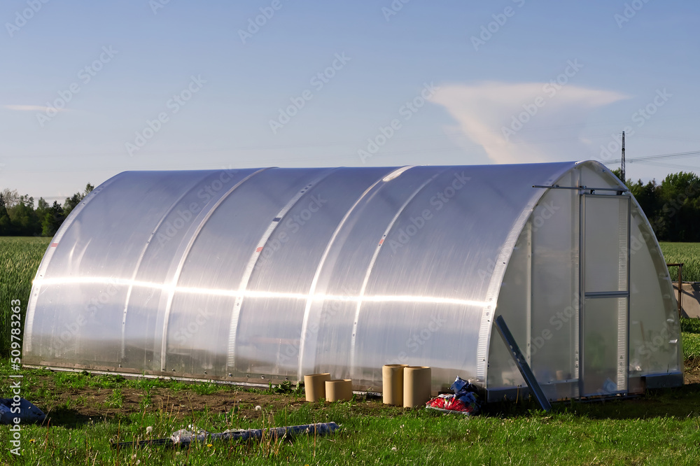 large plastic greenhouse in the garden. close up large plastic greenhouse in the garden. close up
