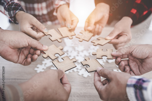 Group of business people assemble jigsaw puzzles, concepts of cooperation, teamwork, help and support in business, symbol of association and connection. business strategy.