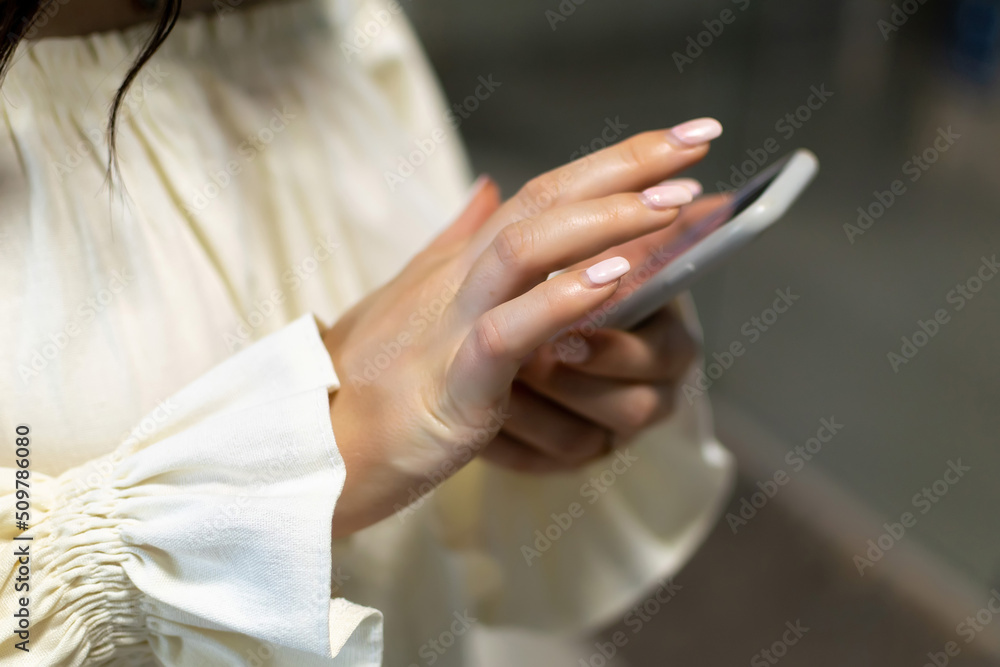 Female hands holding a cell phone