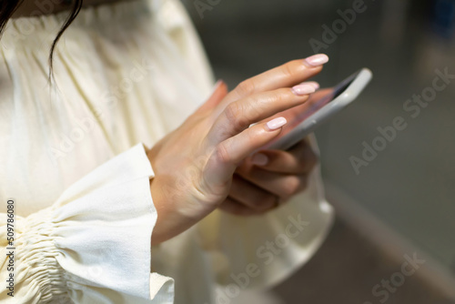 Female hands holding a cell phone © Royalty-Free
