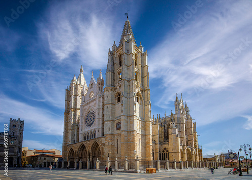 General view of the Gothic Cathedral of León in Castilla y León, Spain, from the square with unrecognizable people walking by
