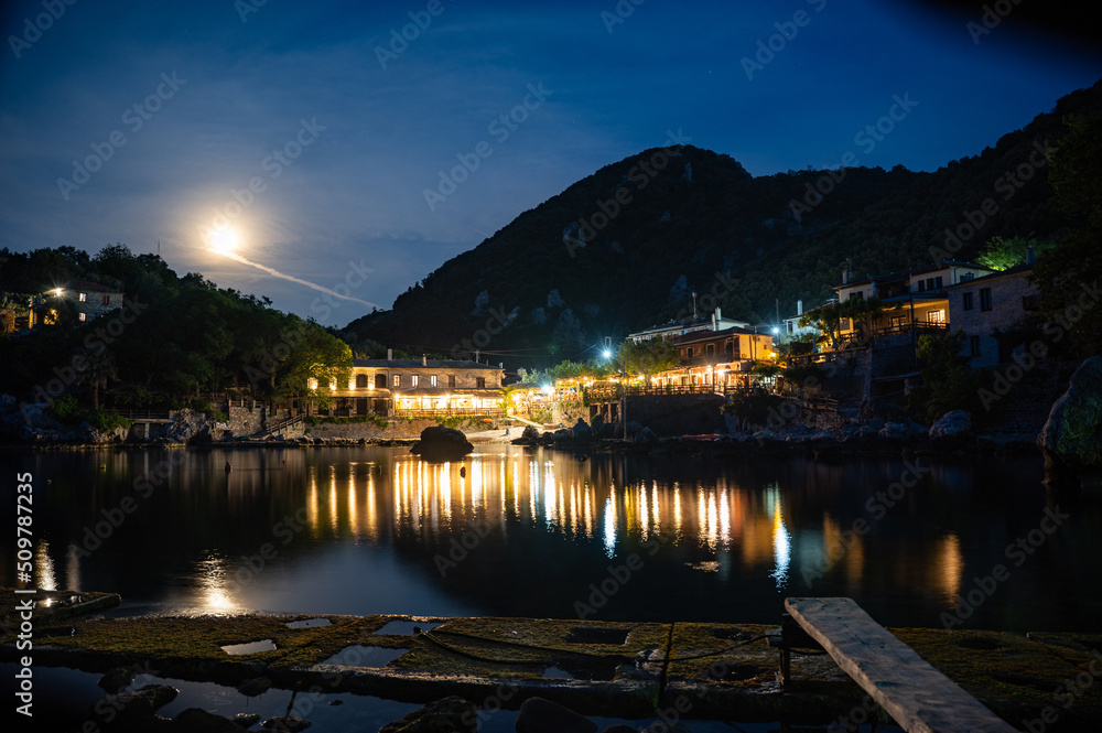 Town of Damouchari (Pelion Peninsula in Greece) at night time with reflections on the water