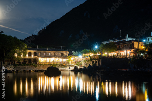 Town of Damouchari (Pelion Peninsula in Greece) at night time with reflections on the water