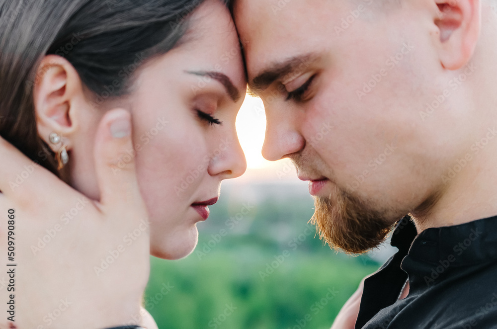 Man and woman touch each other's foreheads with closed eyes Man and woman touch each other's foreheads with closed eyes