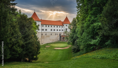 Castle Mokrice on a spring evening with dramatic clouds and forest. A fortress in the woods.