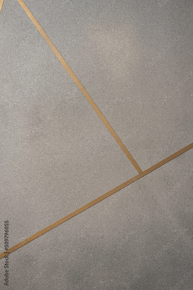 Grey texture. Vertical concrete background with gold inserts for design
