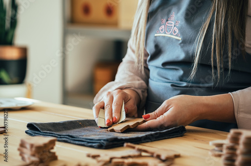 Small Zero Waste Business: Close Up Photo Of Woman Hands Polishing With Sand Paper A Fir Tree Made Of Clay At Her Workshop Desk