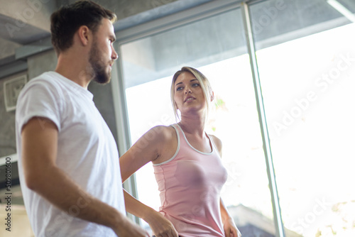 Free Download Sport men and women doing stretch before exercise in fitness gym - GFXLoad