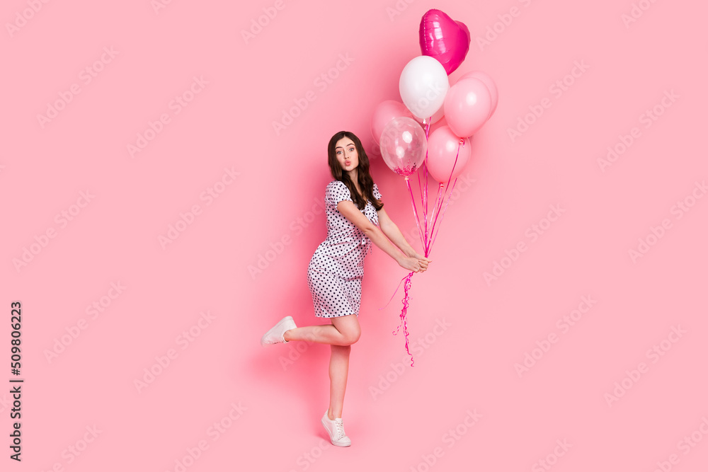 Photo of flirty sweet woman wear white dress sending kiss holding air balls isolated pink color background
