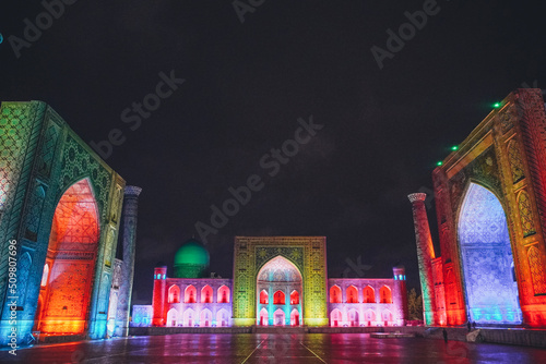 Registan square in Samarkand lit in colourful lights, Uzbekistan photo
