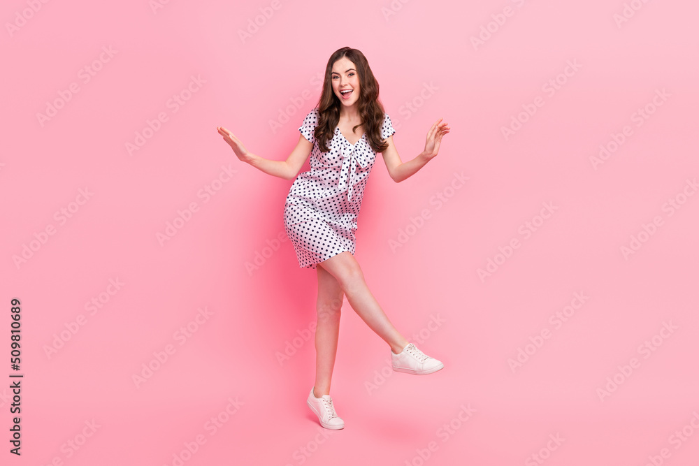 Photo of cute pretty sweet lady dressed dotted dress dancing walking isolated pink color background Photo of cute pretty sweet lady dressed dotted dress dancing walking isolated pink color background