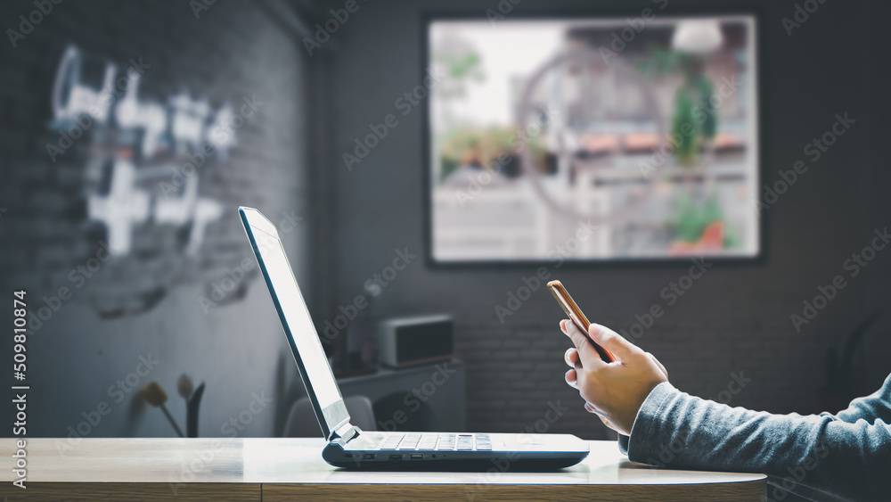 Working on a laptop computer with an electronic document icon is a freelance businessman. Online document database for electronic document management paperless office concept. Working on a laptop computer with an electronic document icon is a freelance businessman. Online document database for electronic document management paperless office concept.