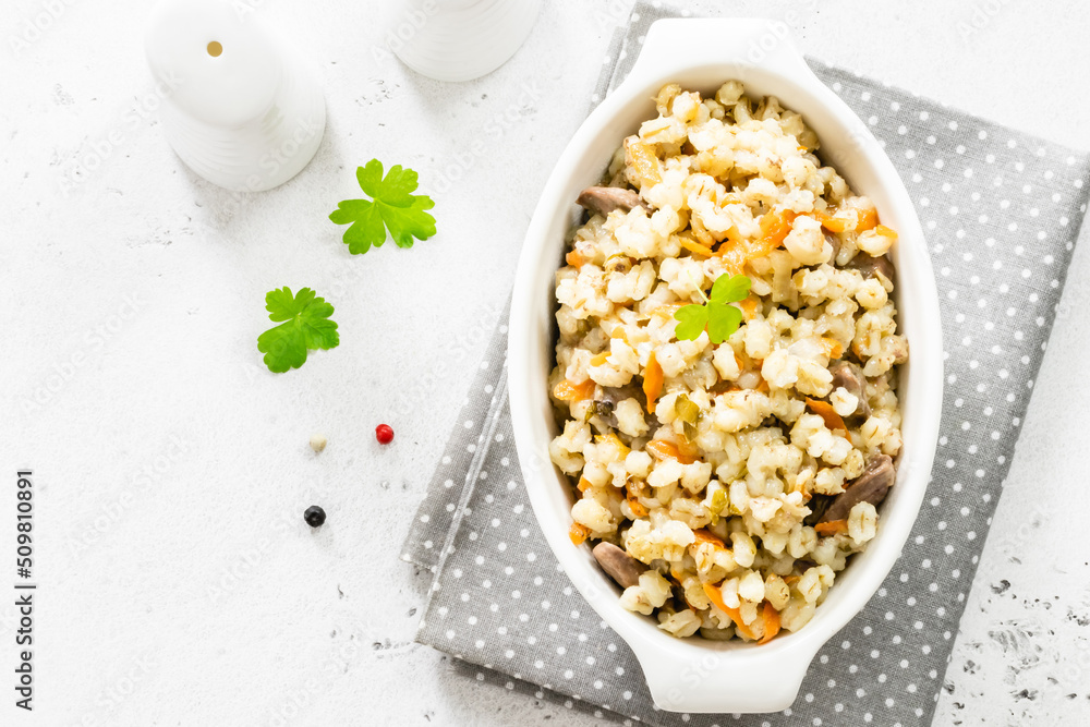 Barley porridge with vegetables and chicken. Top view, copy space, flat lay. Barley porridge with vegetables and chicken. Top view, copy space, flat lay.