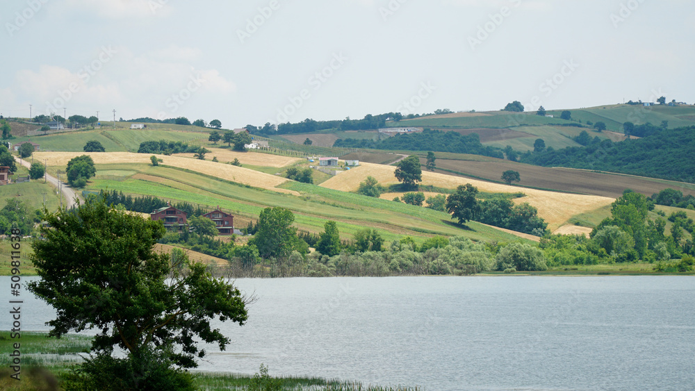 landscape with lake, fields, and hills landscape with lake, fields, and hills