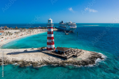 Lighthouse on the island and cruise ship in the blue lagoon, Bahamas Island, View from drone, View from the top, Bahamas from the sky, Top view on beautiful sea © Evgeniia