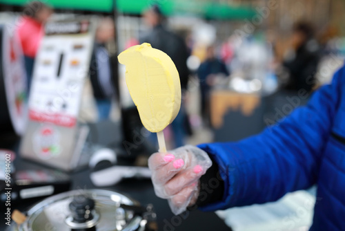 Person holding mango ice cream