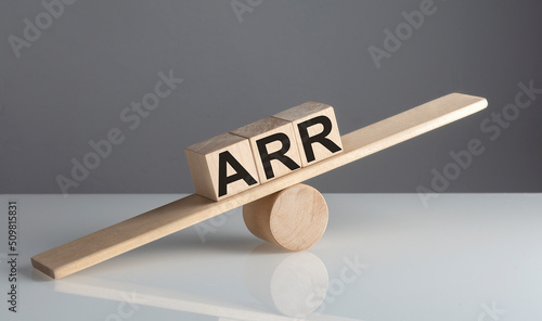 ARR ACCOUNTING RATE OF RETURN text on wooden cubes on a wooden balance , business concept photo