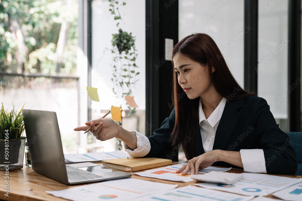 Financial Business woman analyze the graph of the company's performance to create profits and growth, Market research reports and income statistics, Financial and Accounting concept. Financial Business woman analyze the graph of the company's performance to create profits and growth, Market research reports and income statistics, Financial and Accounting concept.