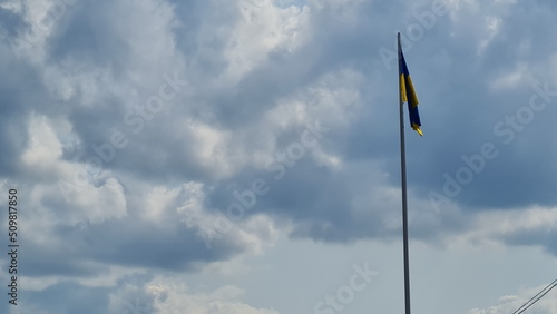 Ukrainian flag against blue sky background