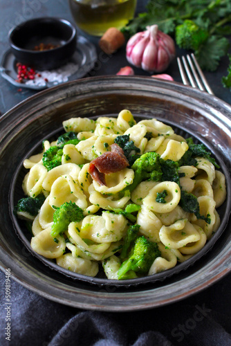 Italian pasta Orecchiette with brocoli and anchovies on dark table. Top view with copy space. Healthy food.