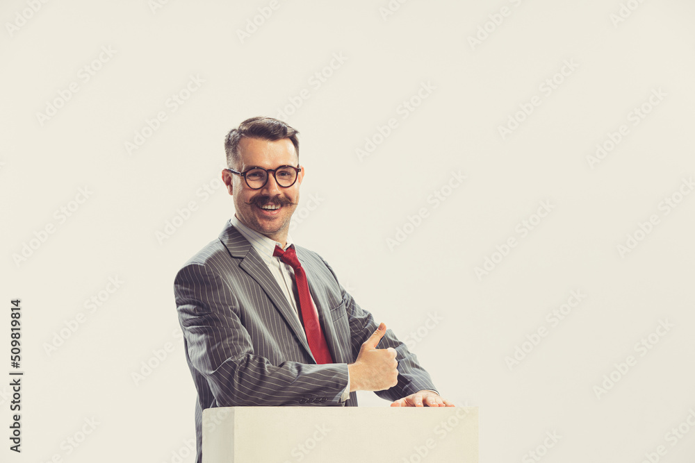 Portrait of smiling businessman wearing grey striped suit in 50s, 60s fashion style isolated on white background. Retro vintage style, business, ad Portrait of smiling businessman wearing grey striped suit in 50s, 60s fashion style isolated on white background. Retro vintage style, business, ad
