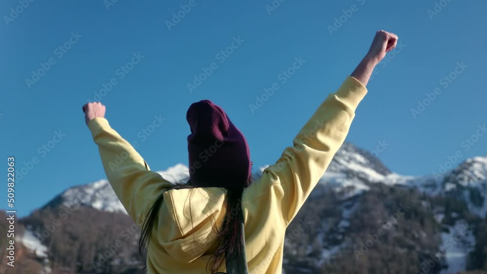 Young woman traveller relax and enjoy winter or spring mountain landscape with sunrise blue sky. 