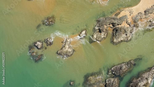 Aerial top view of seascape with wave on rocky and sand beach for travel and relax footage.