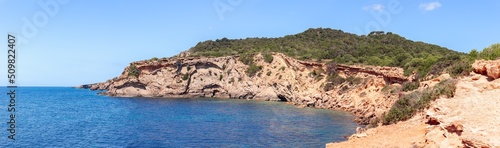 Panoramic view of part of rocky steep coast in the southeast of Ibiza island and clear sea, Balearic Islands, Spain