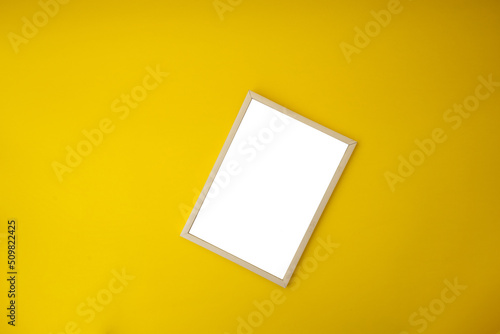 White photo frame on yellow background