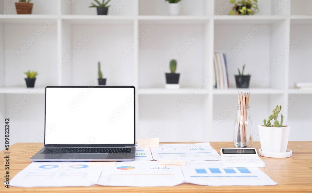 Close up of modern office desktop with blank white notebook screen, smartphone, coffee cup, supplies and other items. Mock up Close up of modern office desktop with blank white notebook screen, smartphone, coffee cup, supplies and other items. Mock up