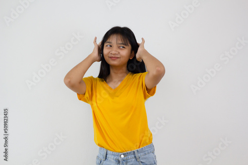 Samrt young girl wear yellow shirt and Jean smilling on white background. photo