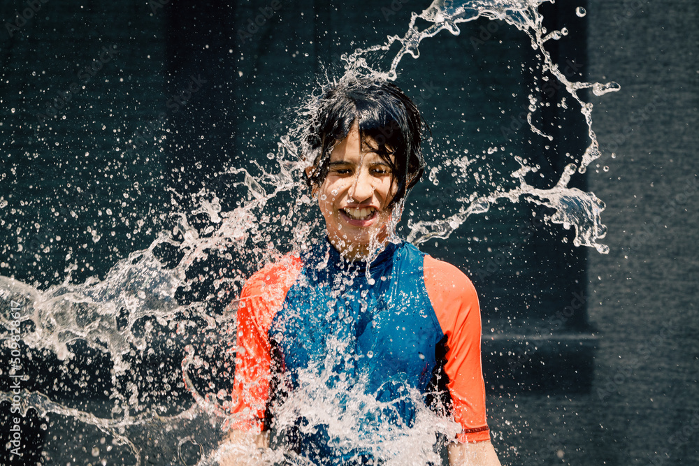 Fototapeta premium Happy girl washing her body with water
