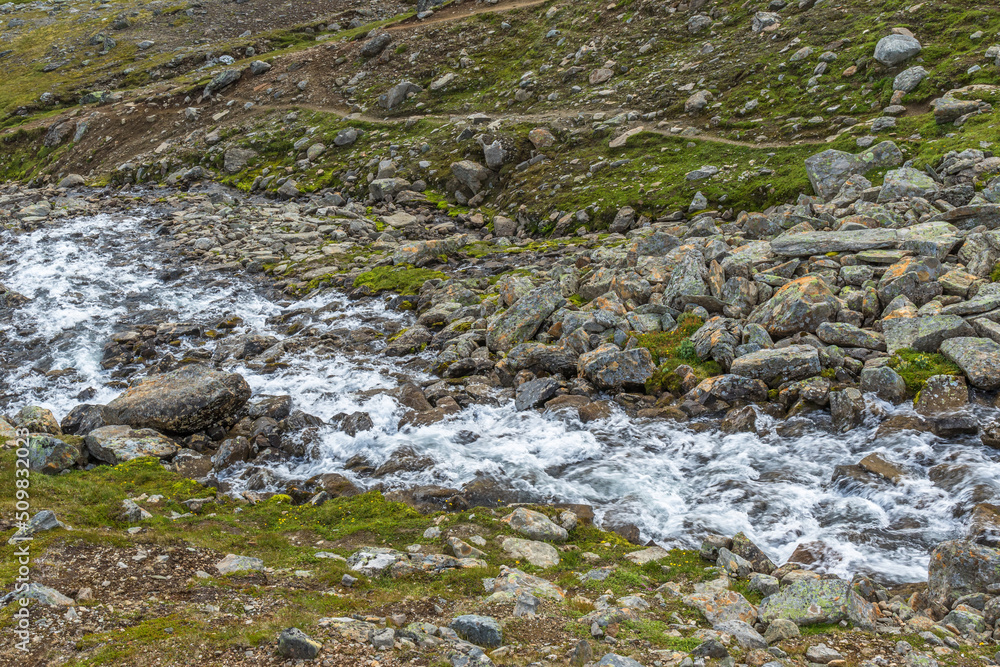 Running water in a stream at a rocky ravine Running water in a stream at a rocky ravine