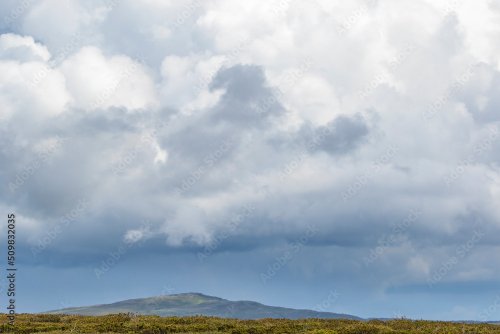 Storm clouds in the sky over a mountain summit Storm clouds in the sky over a mountain summit
