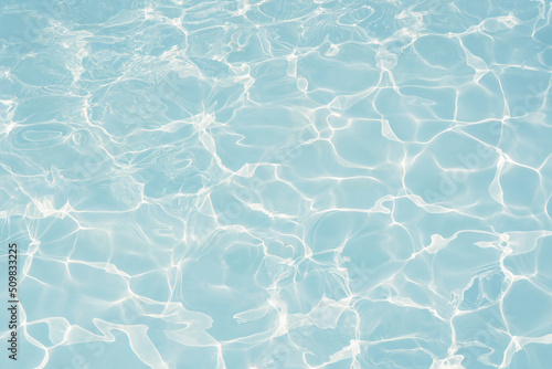 blue water in swimming pool background, closeup