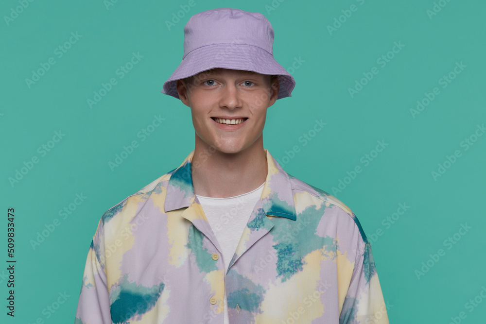 Indoor portrait of young blonde man posing over beige background looking into camera with shocked,horrified facial expression Indoor portrait of young blonde man posing over beige background looking into camera with shocked,horrified facial expression