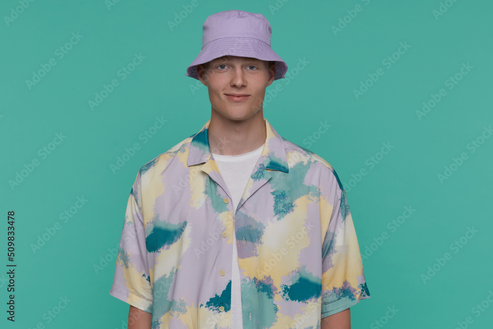 Indoor portrait of young blonde man posing over beige background looking into camera with shocked,horrified facial expression Indoor portrait of young blonde man posing over beige background looking into camera with shocked,horrified facial expression